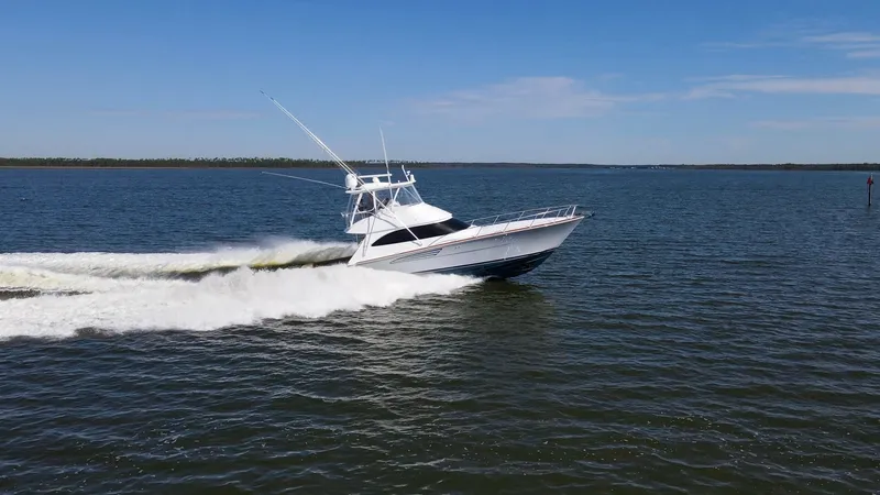 Slide: The Image of Viking 54 Convertible Cruising The 2024 Viking 54 Convertible, Nomad, is seen gracefully slicing through open waters. Its sleek hull design and powerful engines provide a smooth, commanding ride, perfect for both leisurely cruises and offshore adventures. The vessel's aerodynamic profi - 8439827