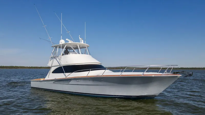 Slide: The Image of Starboard Bow View The 2024 Viking 54 Convertible, Nomad, showcases its sleek starboard bow design, cutting through the water with ease. The elegant lines and robust railing enhance both safety and style, while the flybridge offers panoramic views for superior navigation. T - 8439835