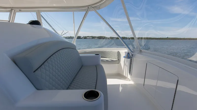 Slide: The Image of Flybridge Seating with Panoramic Views The 2024 Viking 54 Convertible's flybridge features plush, diamond-stitched seating, offering comfort and style. The expansive windows provide breathtaking panoramic views, enhancing the open and airy feel. Integrated cup holders and sleek finishes make t - 8439793