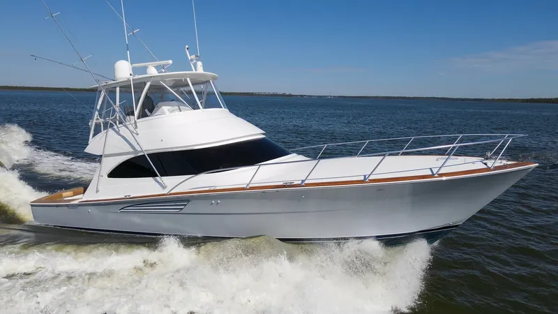 Slide: The Image of Starboard Profile in Motion The 2024 Viking 54 Convertible 'Nomad' showcases its sleek starboard profile as it cuts through the water with ease. Featuring a beautifully contoured hull and a striking white finish, the vessel exemplifies modern elegance and performance. The spacious f - 8439833