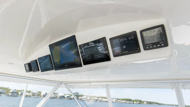Slide: The Image of Flybridge Electronics Console The flybridge of the 2024 Viking 54 Convertible 'Nomad' features a sleek electronics console equipped with state-of-the-art navigation and communication systems. Multiple high-resolution displays provide clear and comprehensive data, ensuring optimal cont - 8439798