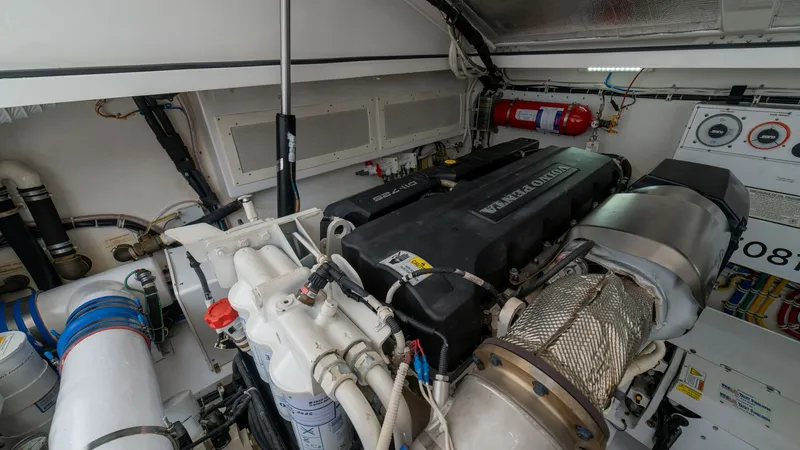 Slide: The Image of Engine Room with Volvo Penta Engine The engine room of the 2020 Cabo 40 Express 'Knot Working' showcases a powerful Volvo Penta engine, emphasizing reliability and performance. The well-organized space features essential components like the exhaust system and fuel filters, all arranged for - 8511601