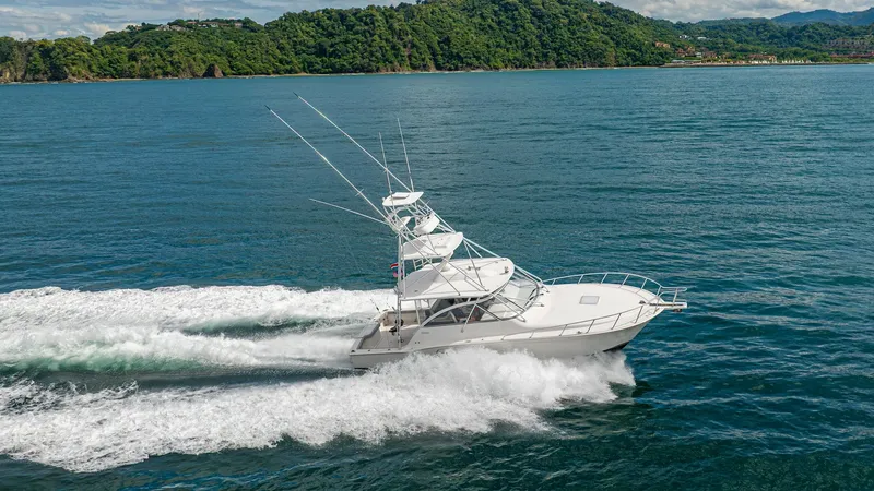 Slide: The Image of Aerial View of Cabo 40 Express This dynamic aerial shot captures the Cabo 40 Express slicing through the water with power and grace. The sleek, white hull and sturdy flybridge highlight its robust design, perfect for offshore adventures. The spacious cockpit is ideal for fishing or lei - 8511612