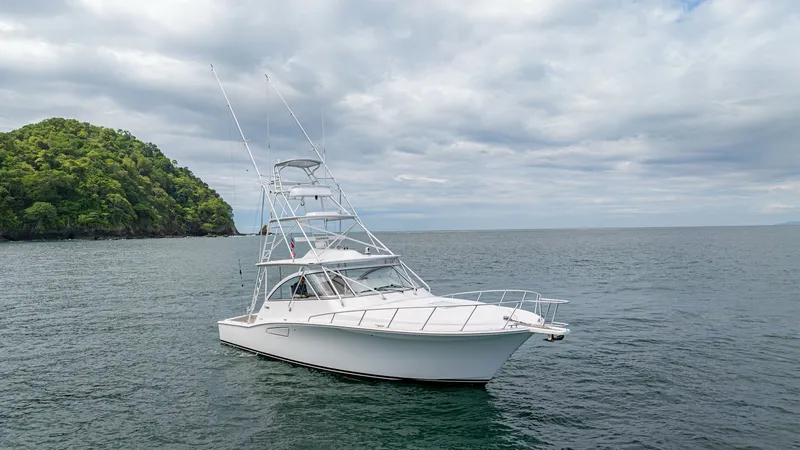 Slide: The Image of Starboard View with Tower The 2020 Cabo 40 Express 'Knot Working' is shown in a serene marine setting, highlighting its sleek starboard profile. The vessel features a robust tuna tower, ideal for sport fishing and offering excellent vantage points. With a streamlined hull and spac - 8511606