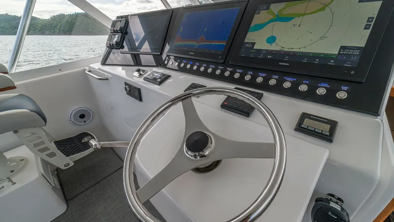 Slide: The Image of Helm Station with Advanced Electronics The helm station of the 2020 Cabo 40 Express 'Knot Working' features state-of-the-art navigation and control systems. Equipped with multiple large displays, the console offers comprehensive charting and radar capabilities for optimal navigation. The ergon - 8511596