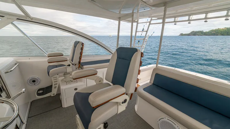 Slide: The Image of Helm Station with Seating The helm station of the 2020 Cabo 40 Express, 'Knot Working', showcases comfortable, adjustable captain's chairs with sleek blue and white upholstery. The open design offers panoramic views, enhancing navigation and enjoyment. The spacious seating area to - 8511598