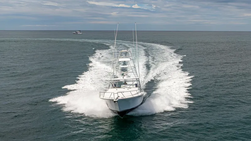 Slide: The Image of Dynamic Bow View at Speed The 2020 Cabo 40 Express, 'Knot Working', is captured cutting through the water with impressive speed and agility. The bow view highlights the sleek, aerodynamic design and robust construction, ideal for offshore adventures. The vessel's powerful wake emp - 8511614