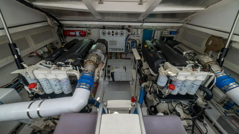 Slide: The Image of Engine Room with Twin Engines The engine room of the 2020 Cabo 40 Express, 'Knot Working,' showcases a well-organized layout featuring twin engines. The space is equipped with advanced filtration systems and accessible controls, ensuring optimal performance and maintenance. Bright ove - 8511600
