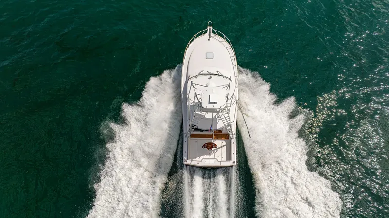 Slide: The Image of Aerial View of Cabo 40 Express This dynamic aerial shot captures the Cabo 40 Express in full stride, showcasing its sleek, aerodynamic design cutting through the water. The vessel's elegant lines and spacious deck are highlighted against the vibrant blue sea, emphasizing its robust per - 8511616