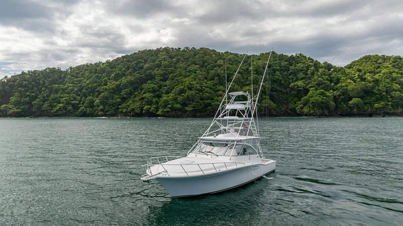 Slide: The Image of Bow View with Tower The 2020 Cabo 40 Express 'Knot Working' showcases a sleek bow with a commanding tower, ideal for sport fishing and ocean adventures. The vessel's elegant lines and sturdy construction are highlighted against a serene backdrop. Its spacious deck and modern - 8511605