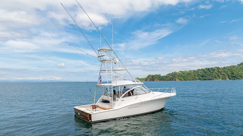 Slide: The Image of Stern View with Tower and Cockpit This stunning Cabo 40 Express, 'Knot Working', showcases a sleek design with a robust fishing tower and well-equipped cockpit. The expansive aft deck offers ample space for fishing or lounging, while the polished teak accents add a touch of elegance. Perf - 8511607