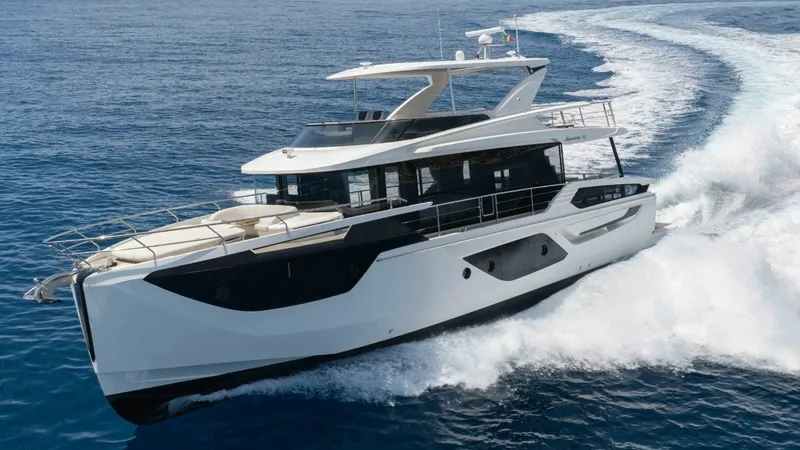 Slide: The Image of Side Profile View in Motion The 2026 Absolute Navetta 58, named MAVI, is captured in full stride, showcasing its sleek, modern design and elegant lines. The expansive windows provide ample natural light to the interior while the upper deck offers a spacious area for relaxation and e - 8640162