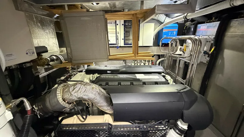 Slide: The Image of Engine Room with Dual Motors This image showcases the meticulously organized engine room of the 2026 Absolute Navetta 58. Featuring dual engines, the space is designed for efficient performance and easy maintenance access. The room's clean layout and advanced control systems highligh - 8640160