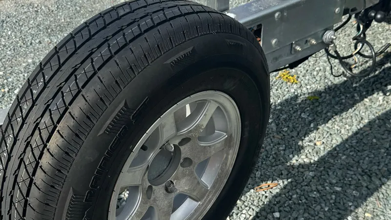 Slide: The Image of Trailer Wheel and Hub Detail This image showcases the robust wheel and hub of the 2023 SeaVee 270Z's trailer. The durable construction ensures stability and reliable performance during transport. The sleek, polished wheel design complements the vessel's premium quality, making it ide - 8398138