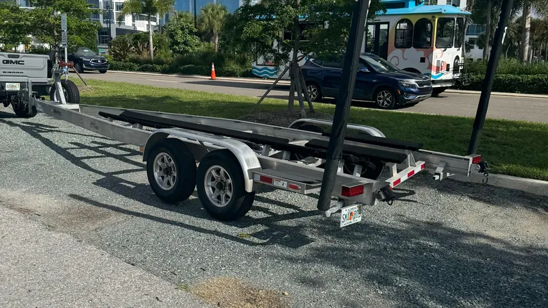 Slide: The Image of Boat Trailer for SeaVee 270Z This image showcases a sturdy trailer designed for the SeaVee 270Z, facilitating easy transportation and storage. The dual axle setup provides enhanced stability and weight distribution, ideal for supporting the vessel's structure. Its robust construction - 8398134