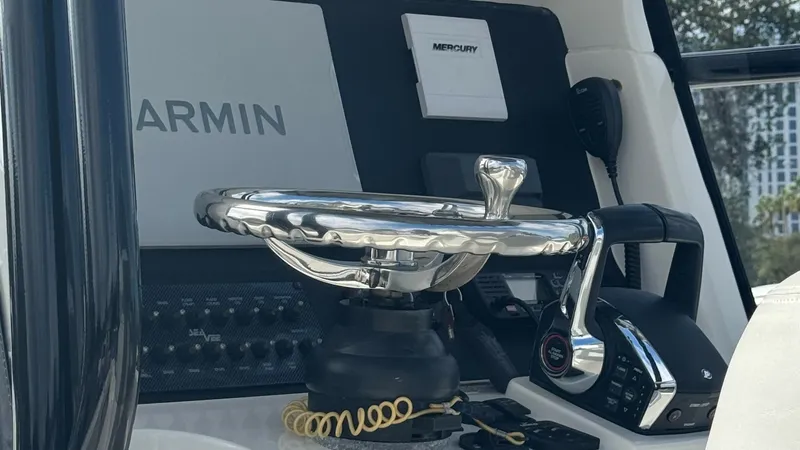 Slide: The Image of Helm Station with Electronics The helm station of the 2023 SeaVee 270Z features a modern and sleek design, equipped with state-of-the-art Garmin electronics for precise navigation. The polished steering wheel and ergonomic controls ensure a comfortable and responsive driving experienc - 8398128