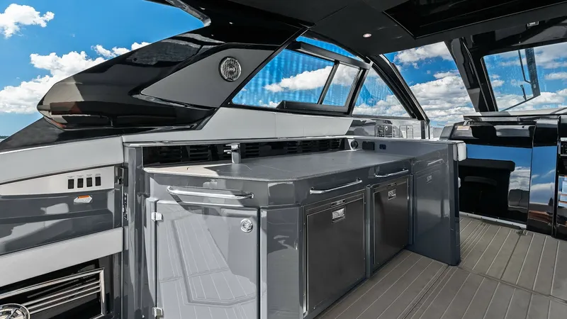 Slide: The Image of Cockpit Wet Bar with Storage The cockpit of the 2023 Cruisers Yachts 42 GLS features a sleek wet bar equipped with ample storage and refrigeration options. The modern design, highlighted by glossy finishes and clean lines, provides a stylish yet functional space for entertaining gues - 8619131