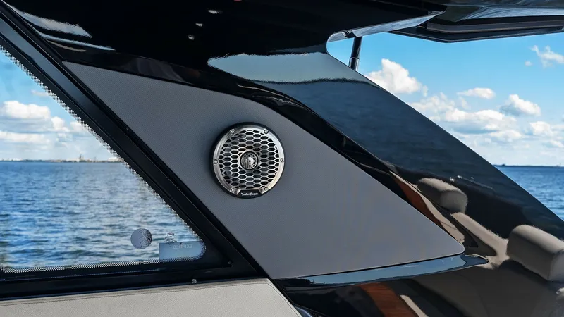 Slide: The Image of Exterior Side Detail with Speaker The sleek exterior of the 2023 SALINTE 42 GLS by Cruisers Yachts features an integrated speaker, enhancing the onboard entertainment experience. The stylish design combines glossy black and matte finishes, providing a modern aesthetic. This view offers a - 8619135