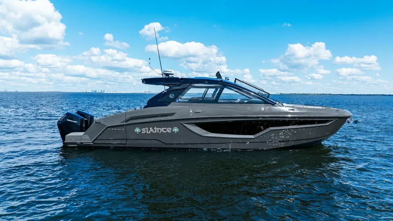 The Image of Side Profile of 2023 Cruisers Yachts 42 GLS This image showcases the sleek and modern side profile of the 2023 Cruisers Yachts 42 GLS, named SALINTE. The vessel features a striking dark hull with streamlined windows, providing a contemporary and elegant aesthetic. Equipped with powerful outboard en - 8619124