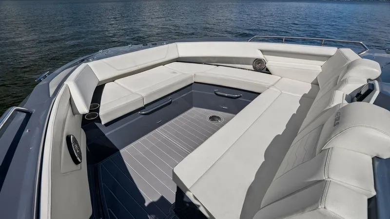 Slide: The Image of Spacious Bow Lounge Area The bow lounge area of the 2023 Cruisers Yachts 42 GLS offers ample seating with plush, white upholstery, perfect for relaxation and socializing. The sleek, modern design is complemented by integrated speakers and cup holders, ensuring comfort and conveni - 8619143
