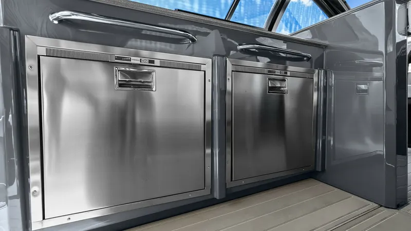 Slide: The Image of Outdoor Galley with Stainless Appliances Experience seamless entertaining with the outdoor galley on the 2023 Cruisers Yachts 42 GLS. This area features sleek stainless steel appliances, ideal for preparing meals while enjoying the open air. The modern design and high-quality finishes offer both - 8619132