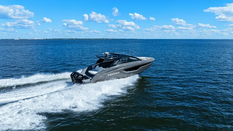 Slide: The Image of Cruisers Yachts 42 GLS at Sea The 2023 Cruisers Yachts 42 GLS, named SALINTE, effortlessly cruises through open waters, showcasing its sleek and modern design. The powerful outboard engines propel the vessel smoothly, while the streamlined hull and elegant lines enhance its dynamic pe - 8619173