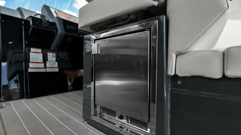 Slide: The Image of Cockpit Seating with Integrated Refrigerator This image showcases the sleek and functional design of the 2023 Cruisers Yachts 42 GLS's cockpit area. The integrated stainless steel refrigerator is seamlessly built into the seating, offering easy access to refreshments while maintaining a clean and mo - 8619133