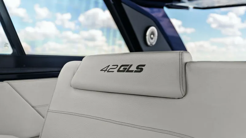 Slide: The Image of Cockpit Seating with 42 GLS Branding The elegant cockpit seating on the 2023 Cruisers Yachts 42 GLS features luxurious upholstery with prominent branding on the headrest. The sleek design is complemented by the spacious and open layout, allowing for an inviting and comfortable onboard experi - 8619138