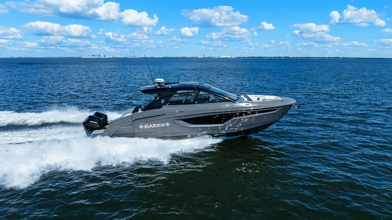 Slide: The Image of Side View Cruising at Speed The 2023 Cruisers Yachts 42 GLS, named SALINTE, is captured in motion, showcasing its sleek design and powerful performance on open waters. This side profile highlights the vessel's aerodynamic hull and modern styling, complemented by robust outboard engi - 8619174