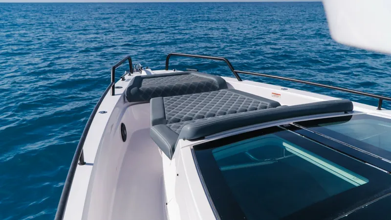 Slide: The Image of Bow Sunbathing Area with Cushions The bow of the 2022 Axopar 37 Barbus features a luxurious sunbathing area with plush, diamond-stitched cushions. This inviting space offers ample room for relaxation while enjoying panoramic views of the open sea. The sleek, modern design is complemented - 8439366