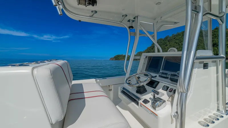 Slide: The Image of Helm Station with Dual Seating The helm station of the 2013 SeaVee 32, Poco Mas, features a sleek and modern design with advanced navigation systems and dual seating for comfort and functionality. The dashboard is equipped with state-of-the-art electronics, providing all necessary cont - 8738104