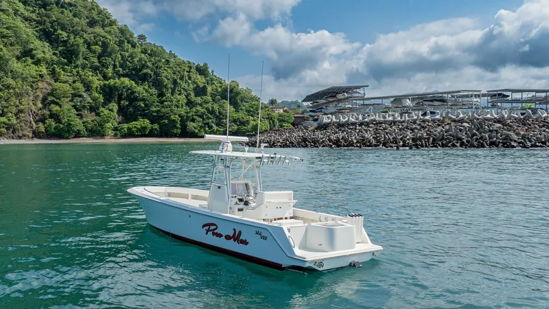 Slide: The Image of Starboard View of SeaVee 32 This image showcases the sleek profile of the 2013 SeaVee 32 model, 'Poco Mas,' gliding effortlessly through the water. The vessel features a clean, open deck layout with a sturdy T-top, perfect for fishing or leisurely cruising. Its elegant lines and rob - 8738109