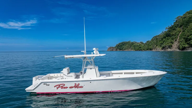 The Image of Side Profile of SeaVee 32 The 2013 SeaVee Model 32, named Poco Mas, is elegantly showcased on calm waters, highlighting its sleek hull design. The vessel features a T-top for shade and protection, along with spacious deck areas ideal for fishing or leisure. Its clean lines and bal - 8738097