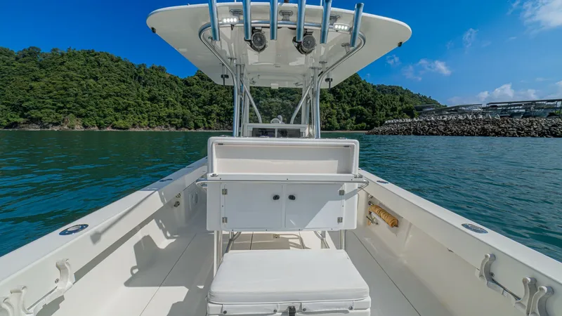 Slide: The Image of Center Console with T-Top This image showcases the sleek center console of the 2013 SeaVee 32, featuring a sturdy T-top equipped with rod holders and overhead lighting. The spacious deck layout provides ample room for maneuvering, while the central seat offers comfort and storage - 8738105