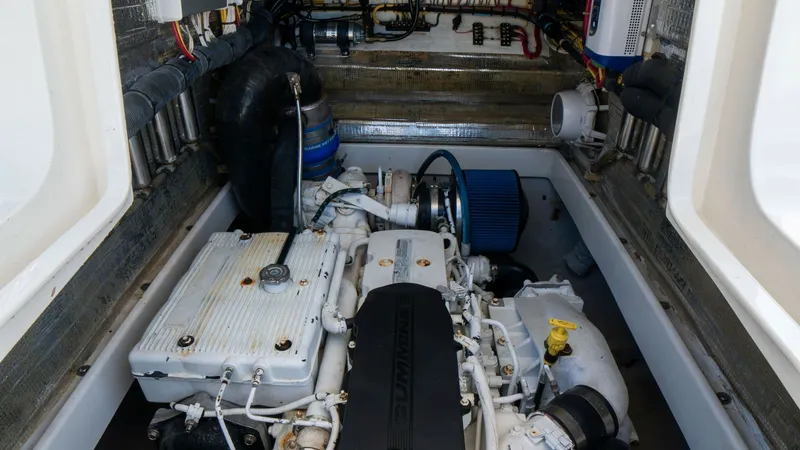 Slide: The Image of Well-Equipped Engine Compartment This image showcases the meticulously maintained engine compartment of the 2013 SeaVee 32, Vessel: Poco Mas. Featuring a powerful and reliable engine setup, the space is optimized for performance and easy access. Neatly arranged wiring and components high - 8738107