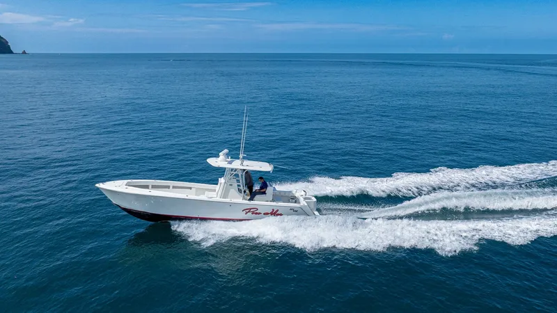 Slide: The Image of Aerial View of SeaVee 32 in Motion This dynamic aerial shot captures the 2013 SeaVee 32, 'Poco Mas,' slicing through the open water with grace and power. The sleek hull and streamlined design are highlighted as it speeds along, showcasing the vessel's agility and performance. The open deck - 8738114