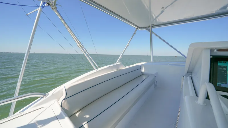 Slide: The Image of Flybridge Seating Area The flybridge of the 2001 Hatteras 60 Convertible offers a spacious seating area with plush, cushioned benches, perfect for relaxing while enjoying panoramic ocean views. The clean, white finish complements the sleek design and provides a comfortable sett - 8734363