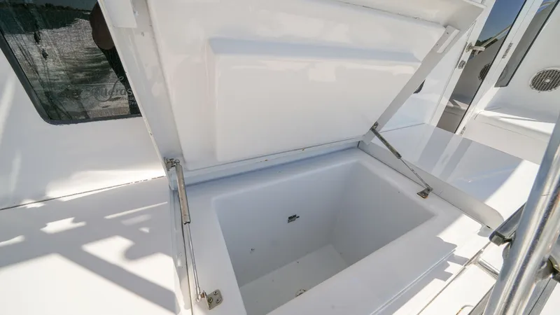 Slide: The Image of Spacious Deck Storage Compartment This image showcases a large deck storage compartment on the 2001 Hatteras 60 Convertible, Uno Mas. The compartment features a sturdy lid with hydraulic hinges for easy access and secure closure. Its ample space is perfect for storing fishing gear, water - 8734351