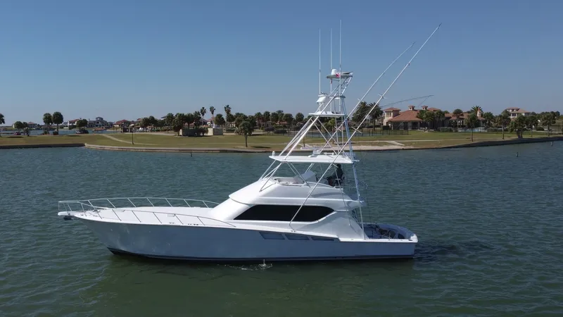 Slide: The Image of Side Profile of Hatteras 60 Convertible The Hatteras 60 Convertible showcases a sleek side profile, emphasizing its classic nautical design and robust construction. The vessel features a spacious flybridge with a tuna tower, ideal for sportfishing enthusiasts. Its elegant lines and solid hull a - 8734374