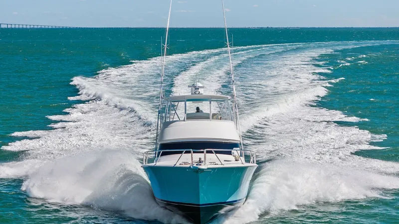 Slide: The Image of Dynamic Bow View in Motion The Viking 54 Convertible, 'Pipe Dream', is captured in a striking bow view as it cuts through the water with power and precision. Its sleek hull design and robust build are highlighted, showcasing the yacht's capability to handle open seas effortlessly. - 8673356