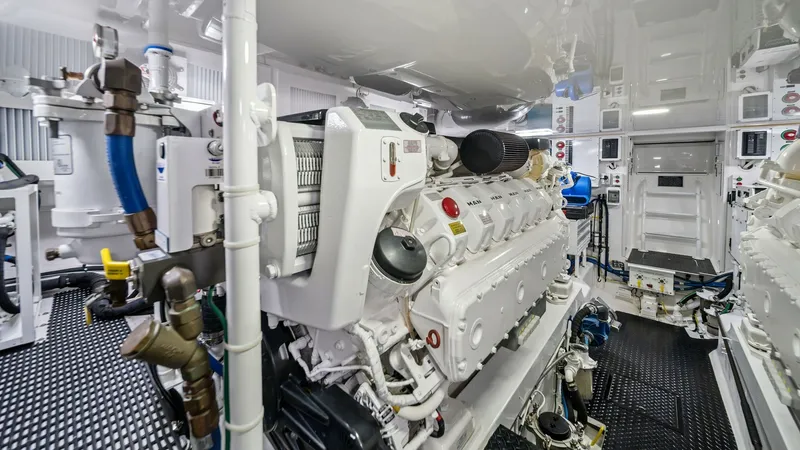 Slide: The Image of Engine Room with Twin Engines The engine room of the Viking 54 Convertible 'Pipe Dream' showcases its powerful twin engines, expertly designed for optimal performance. The space is meticulously organized, featuring high-quality components and a clean, accessible layout for easy mainte - 8673345