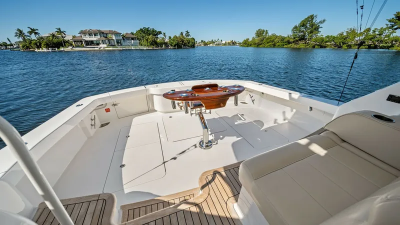 Slide: The Image of Spacious Aft Deck with Fighting Chair The aft deck of the 2021 Viking 54 Convertible 'Pipe Dream' features ample space for fishing and relaxation. A centrally positioned fighting chair is the focal point, surrounded by durable, non-slip flooring and elegant teak accents. The seating area offe - 8673327