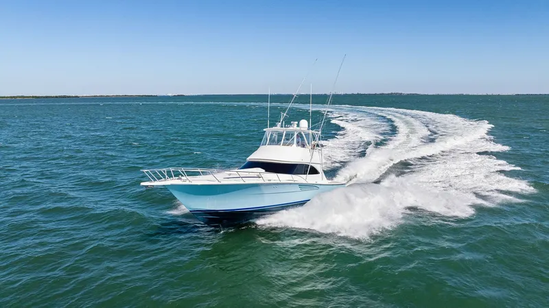 Slide: The Image of Dynamic Bow View at Sea The Viking 54 Convertible cuts through the water with elegance and power, showcasing its sleek hull design and robust performance capabilities. The bow view captures the vessel's streamlined shape and commanding presence, creating an impressive wake as it - 8673357