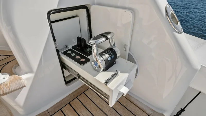 Slide: The Image of Cockpit Control Station This image showcases the cockpit control station on the Viking 54 Convertible, featuring a sleek, retractable panel with state-of-the-art throttle and navigation controls. The station is seamlessly integrated into the aft deck, surrounded by elegant, dura - 8673338
