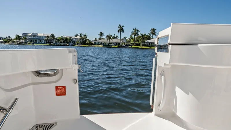 Slide: The Image of Transom Entry with Scenic View This image showcases the transom entry of the 2021 Viking 54 Convertible, providing easy access to the water. The clean, sleek lines and practical design are complemented by a stunning waterfront backdrop, making it ideal for both leisurely activities and - 8673334