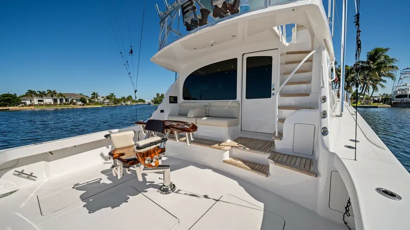 Slide: The Image of Spacious Aft Deck with Seating The aft deck of the 2021 Viking 54 Convertible, 'Pipe Dream', showcases a spacious layout perfect for both relaxation and sportfishing. Featuring a comfortable bench seat and a centrally located fighting chair, this area is designed for both leisure and f - 8673328