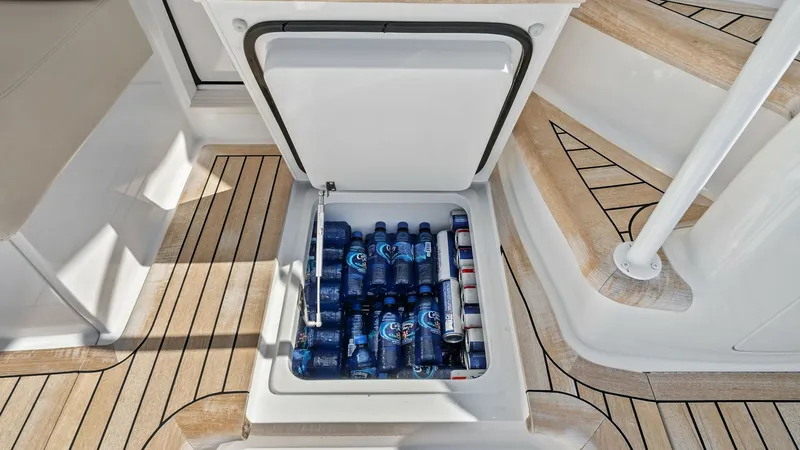 Slide: The Image of Cockpit Deck with Built-in Cooler The Viking 54 Convertible's cockpit features a built-in cooler, seamlessly integrated into the deck. This convenient storage solution keeps beverages chilled and easily accessible, perfect for entertaining on the open water. The high-quality teak flooring - 8673337