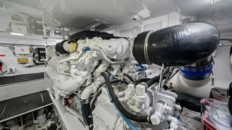 Slide: The Image of Engine Room with Twin Engines This image showcases the meticulously maintained engine room of the Viking 54 Convertible, featuring powerful twin engines. The space is organized and well-lit, highlighting the advanced engineering and robust performance capabilities. Clean lines and acc - 8673342