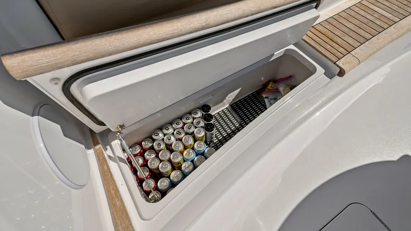 Slide: The Image of Cockpit Storage Compartment This image showcases the convenient cockpit storage compartment on the Viking 54 Convertible. Designed for accessibility, it provides ample space to store beverages, snacks, and essentials, keeping them cool and within easy reach. The sleek, integrated de - 8673335