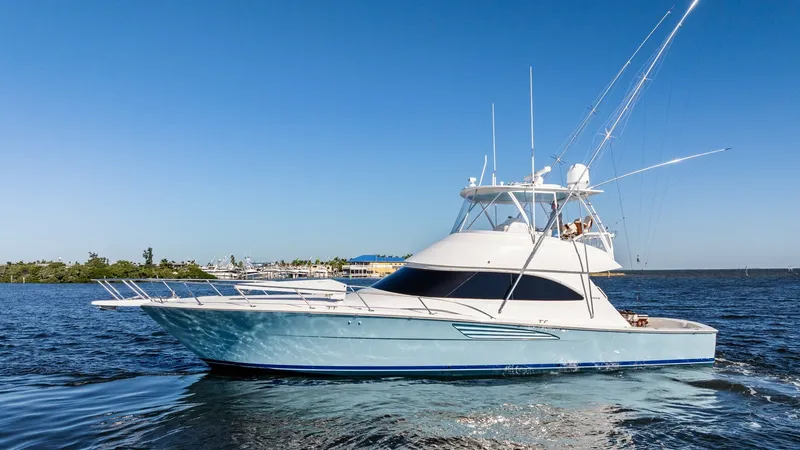The Image of Starboard Profile of Viking 54 Convertible This image showcases the sleek and powerful starboard profile of the 2021 Viking 54 Convertible. The vessel's elegant lines and robust hull design are complemented by a spacious flybridge, ideal for commanding views and navigation. With its striking blue - 8673293